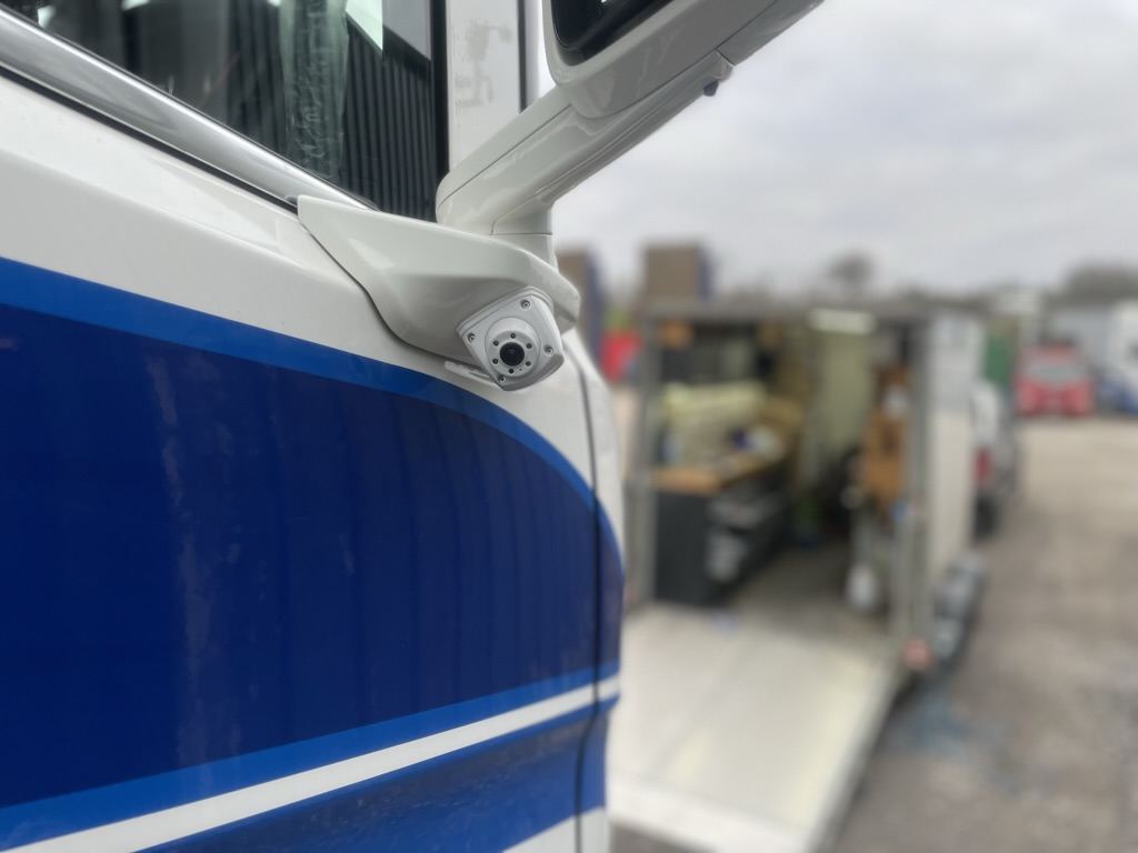 Vehicle CCTV camera fitted under the mirror arm of a truck cab