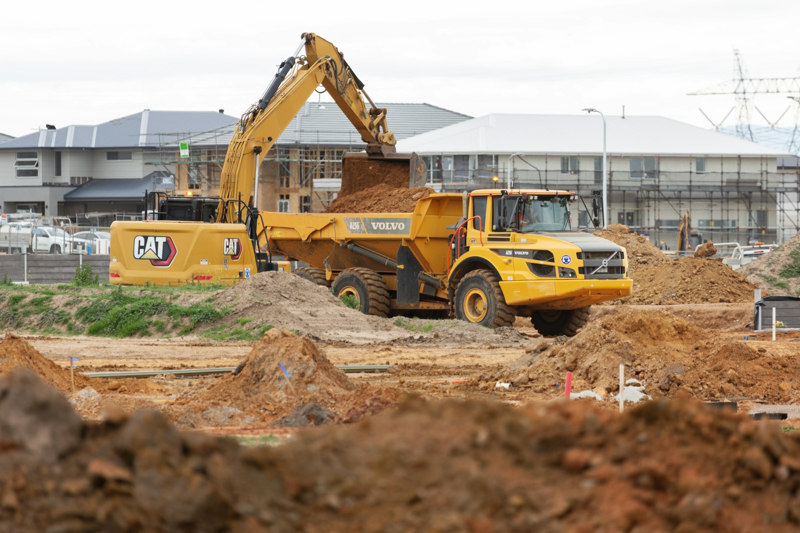 Excavator loading a dumper on a building site