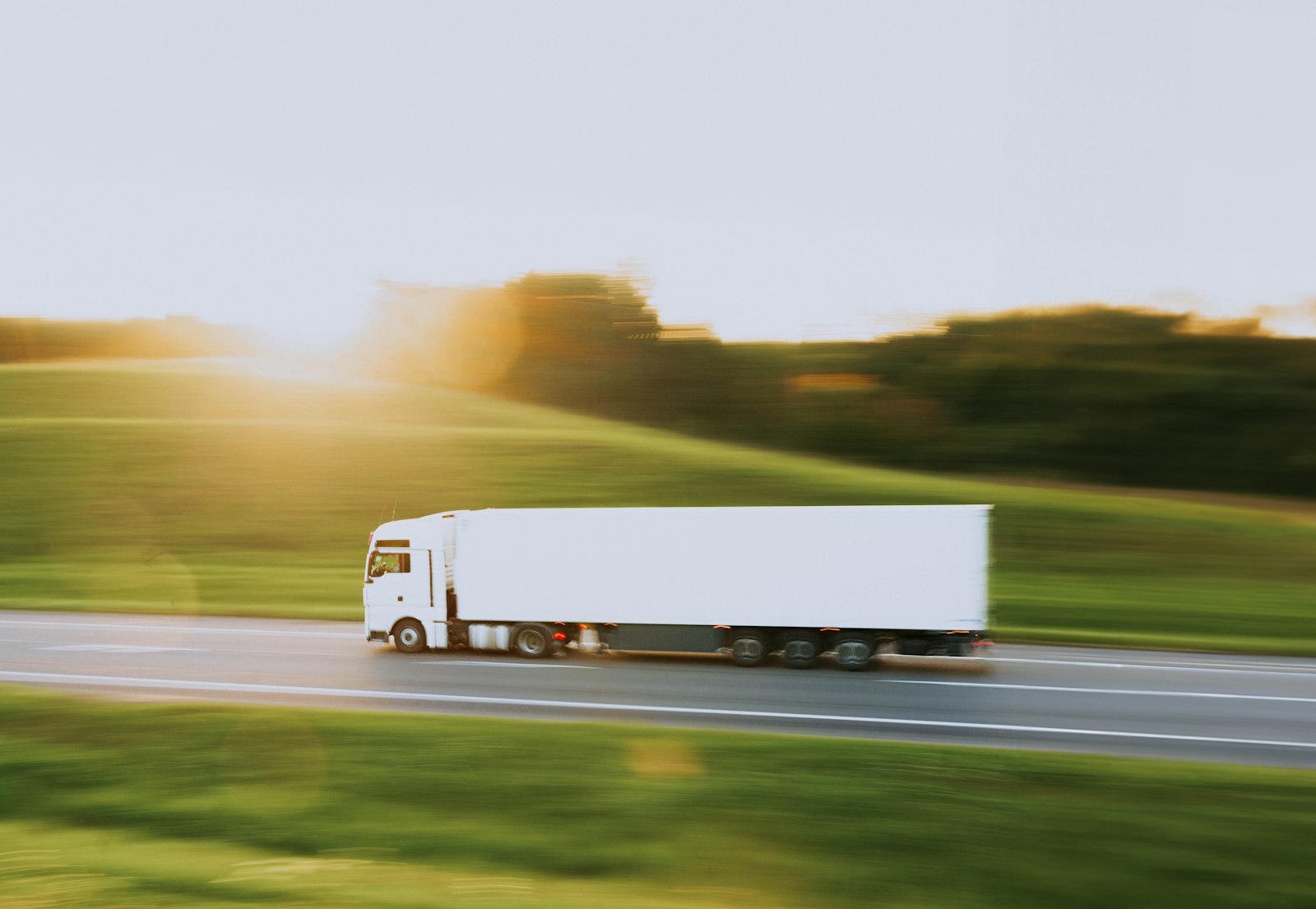 Lorry with a white trailer on a country road